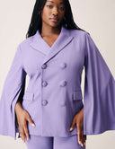 Model wearing the Cool Intentions Blazer in purple with batwing sleeves and dramatic satin lapels.