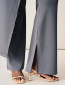 Close-up view of the Cut to the Chase Pant featuring a sleek split design and stylish heels.