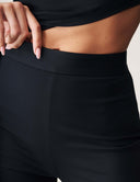 Close-up of the waistband of the Cut to the Chase Pant, showcasing comfort and style in sleek black fabric.