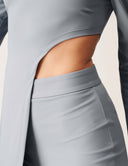 Cut to the Chase Pant showing details of the stylish slit and sleek fit in soft gray fabric.