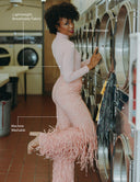 Model showcasing the Dancing Anyone jumpsuit in a laundromat, highlighting its lightweight, breathable, and wrinkle-resistant fabric.
