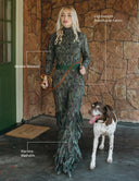 A woman wearing the Going Somewhere jumpsuit with fringe, walking a dog. Features lightweight, breathable fabric.