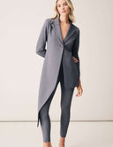 Model showcasing the Keep It Moving Blazer in gray, featuring an open back tuxedo silhouette and flowing lapel.