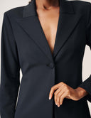 Close-up of the Keep It Moving Blazer featuring a deep neckline and button closure.