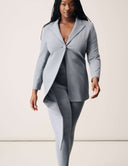 Confident model wearing Keep It Moving Blazer in light gray, styled with coordinating bottoms for a chic look.