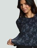 Model showcasing the Luxe Long Sleeve Bodysuit in black lace print, emphasizing style and comfort for a seamless look.