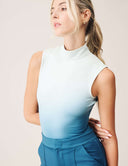 Model wearing Luxe Ombre Bodysuit in tropical fade color with a turtleneck design and fitted silhouette.