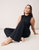 Model wearing Luxe Sleeveless Bodysuit with flared pants and sandals, showcasing versatile style and seamless fit.