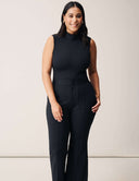 Model wearing a Luxe Sleeveless Bodysuit with black tailored pants, showcasing a sleek, stylish look.