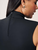 Close-up of Luxe Sleeveless Bodysuit showcasing turtleneck and zipper detail at the back.
