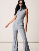 Model showcasing the Luxe Sleeveless Bodysuit in gray, featuring a turtleneck design and sleek fit.