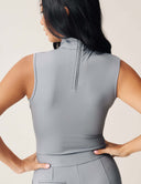 Luxe Sleeveless Bodysuit featuring a sleek design with a turtleneck and zipper closure at the back.