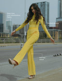 Model wearing a canary yellow Milano Jumpsuit featuring moisture-wicking and four-way stretch fabric.