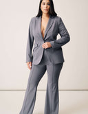 Model wearing the Perfect Form Pant with a matching blazer, showcasing sleek bell-bottom styling and elegant tailored fit.