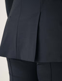 Close-up of the Perfect Form Blazer showcasing its sophisticated tailoring and structured pleat design.