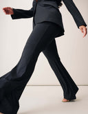 Model wearing Perfect Form Pant with bell bottom styling and tailored fit, paired with a blazer.