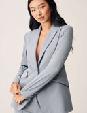 A model wearing the Perfect Form Blazer in light gray, showcasing its sophisticated design and tailoring.