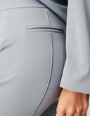 Close-up of the back pocket detail on the Perfect Form Pant in light gray fabric.