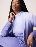 Model wearing a Power Shift Blazer in Lavender Haze with a sleek turtleneck top. Sophisticated style and tailored design.