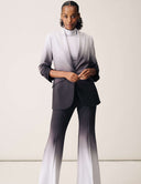 Model wearing the Power Shift Blazer in Tidal Wave gradient style, paired with matching flared pants.