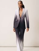 Model wearing the Power Shift Set - Storm Veil featuring a sophisticated blazer and bell bottom pants.