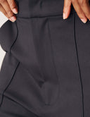 Close-up of the Power Shift Pant, showcasing tailored bell bottom styling and front slant pockets.