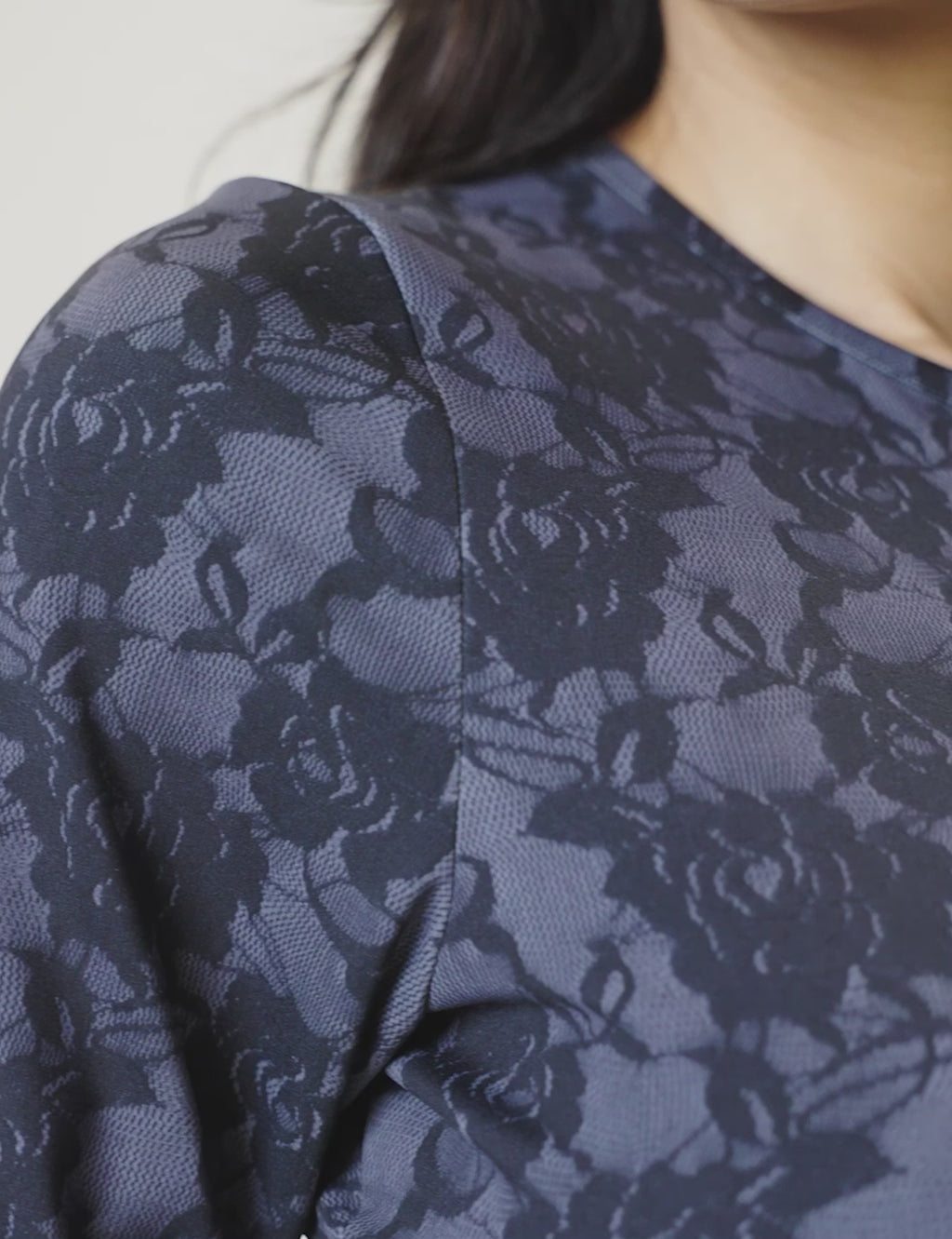 Close-up of the Luxe Long Sleeve Bodysuit featuring blue Italian-inspired lace print and activewear fabric.