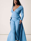Model showcasing the Promise Me Nothing Set - Marina in blue, featuring a deep V-neck, high-low hem, and tapered pants.
