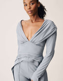 Model wearing the Promise Me Nothing Top featuring a deep V-neckline and structured silhouette.