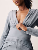 Woman wearing the Promise Me Nothing Top featuring a deep V-neckline and elegant ruching detail.