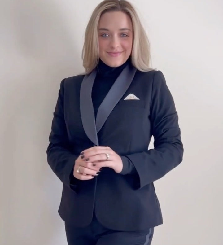 Woman in the Tea Time Set with a pocket square, smiling and posing confidently.
