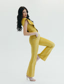 Model showcasing a stylish yellow one-piece jumpsuit with flared legs and a trendy neckline, exuding confidence and elegance.