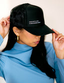 A woman wearing The Classic Cap, showcasing its stylish design and embroidered details.