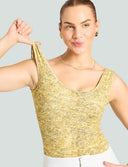 Model showcasing the Iconic Scoop Neck Tank Bodysuit in gold sequin print, perfect for seamless layering and style.