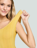 Model showcasing the Iconic Scoop Neck Tank Bodysuit in vibrant yellow, highlighting its comfortable fit and stylish design.